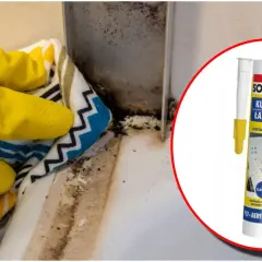 Rękawiczki i ściereczka czyszczą pleśń przy wannie. Obok tubka silikonu sanitarnego Soudal do kuchni i łazienek.